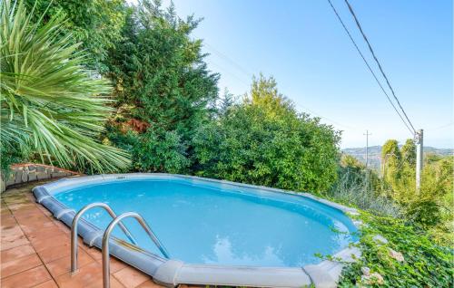a swimming pool in a garden with trees at I Tre Olivi in Valpromaro