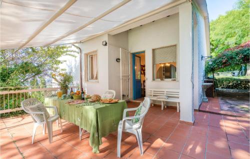 a dining room with a table and chairs on a patio at I Tre Olivi in Valpromaro