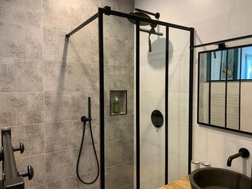 a bathroom with a shower with a glass door at La Parenthese Saint Donat in Aix-en-Provence