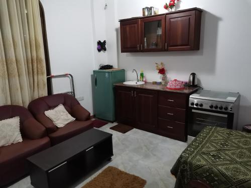 a living room with a couch and a stove at Southern Comforts - Galle Fort in Galle