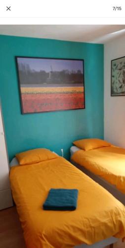 a bedroom with two beds and a painting on the wall at NICOLE, not for parties, not a hotel, room with shared bathroom, no kitchen in Amsterdam