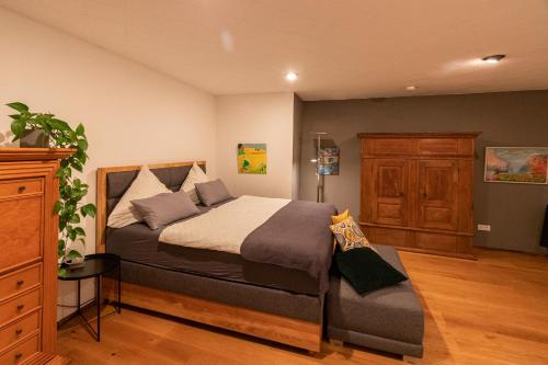 a bedroom with a large bed and a dresser at Komfortwohnung City/Messe 25 Min in Cologne
