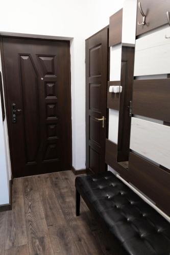 a room with a bench in front of a door at Komló Szíve Apartman in Komló