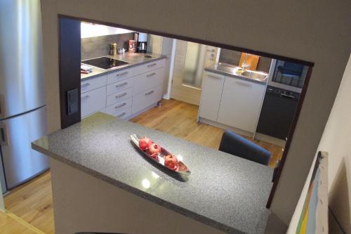 a kitchen with a counter with a bowl of fruit on it at Komfortwohnung City/Messe 25 Min in Cologne