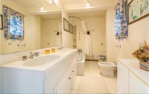 a white bathroom with a sink and a toilet at Il Glicine in Galzignano