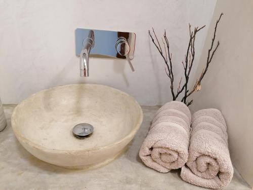 a sink in a bathroom with towels on a counter at Villa Pescadora spectacular view, luxery fisherhouse design in Sal Rei