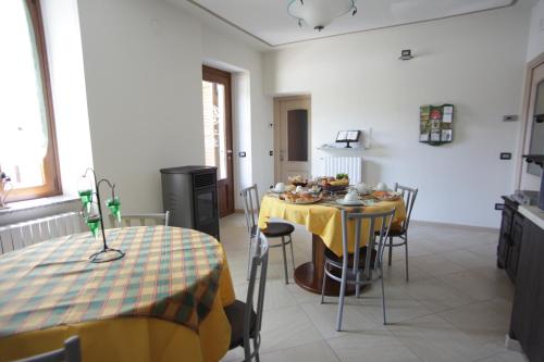 a kitchen with a table with a yellow table cloth at Bed and Breakfast Luna in San Giovanni Bianco