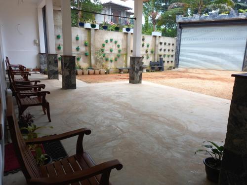 a patio with chairs and a fence and a courtyard at Star Guest in Balangoda