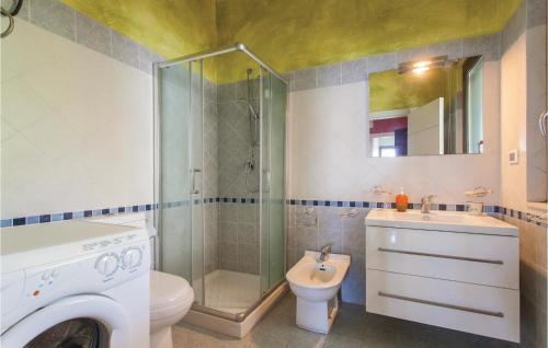 a bathroom with a shower and a toilet and a sink at Praiola in San Leonardello