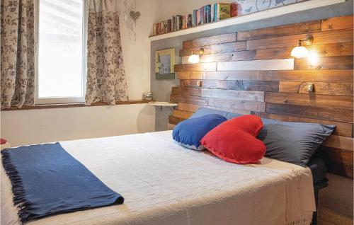 a bedroom with a bed with two pillows on it at Il Kiwi in San Giovanni Alla Vena