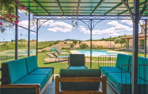 a patio with blue furniture and a swimming pool at Casa Delle Rose in Barchi