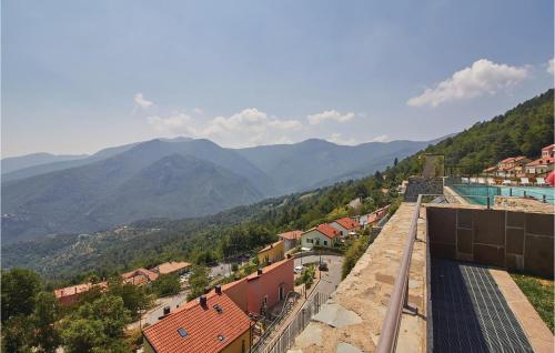 a view of a town with mountains in the background at Awesome Home In Magliolo With Kitchen in Magliolo