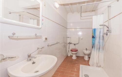 a white bathroom with a sink and a toilet at Palazzo 2P in Polvano
