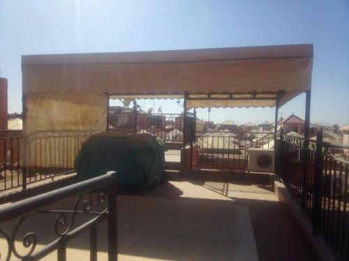 un cenador con cama en un balcón en Riad Naim, en Marrakech