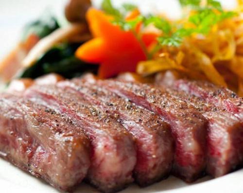 a plate of food with meat and vegetables on it at Higashiomi Large House in Higashiomi