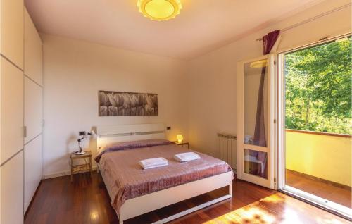 a bedroom with a bed and a large window at Casa Eliana in Carrara