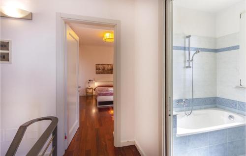 a bathroom with a bath tub and a bedroom at Casa Eliana in Carrara