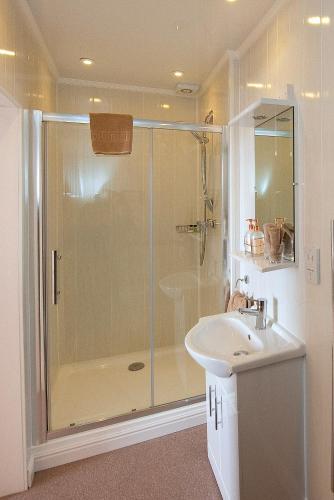 a bathroom with a shower and a sink at Loch Melfort Hotel in Ardfern