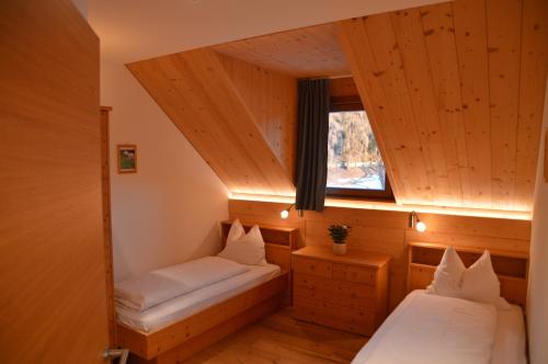 a room with two beds and a window at Lobishof in Soprabolzano