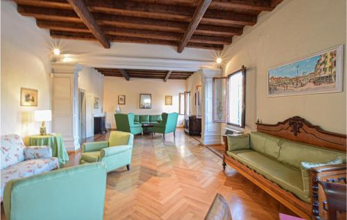 a living room with green couches and chairs at Casa Torre del Castello in Cordovado