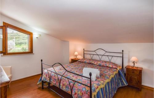 a bedroom with a bed and two tables and a window at Villa Calaforno in Giarratana