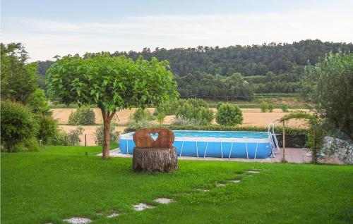 a chair sitting in the grass next to a pool at Amazing Apartment In Cavriana in Cavriana