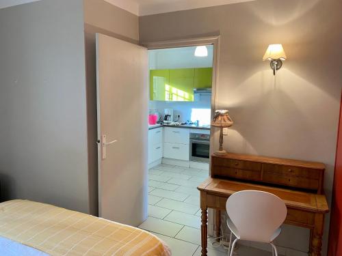 une chambre avec un lit et un bureau et une cuisine dans l'établissement Appartement Front de Mer, à Canet