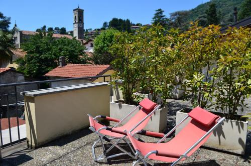 two red chairs sitting on a balcony at Albergo Giardino in Cernobbio