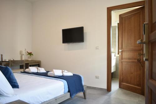 a bedroom with a bed with a tv on the wall at Tenuta Micoli in Frisa