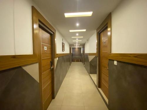 a corridor of a hallway with wooden doors and a hallway at THE PORCH INN in Wayanad