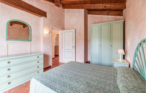 a bedroom with a bed and a dresser at Villa 4 In in Stintino