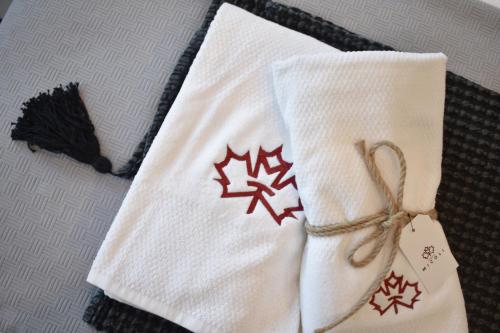a pair of white towels with christmas decorations on them at Tenuta Micoli in Frisa