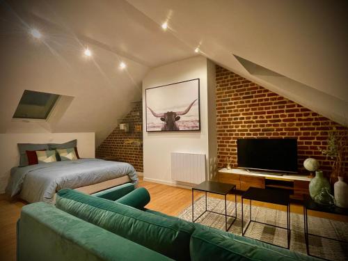 a living room with a couch and a bed at DOWNTOWN LOFT - CENTRE VILLE - WiFi - NETFLIX in Amiens