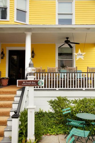 a street sign in front of a yellow house at The Star Inn in Cape May