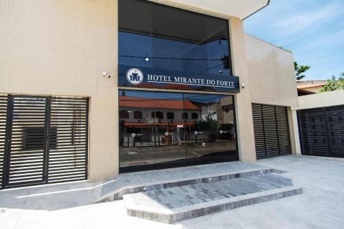 a building with a sign that reads hotel warehouse douce at Hotel Mirante do Forte in Cabo Frio