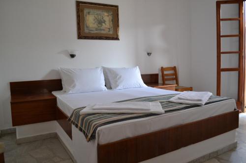 a bed with white sheets and pillows in a room at Bella Casa in Bali