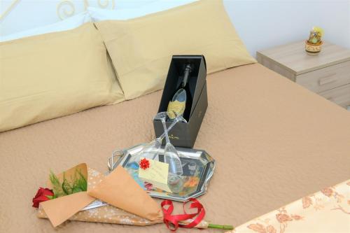 una scatola sopra un letto con regali di Caldi Abbracci a Meta