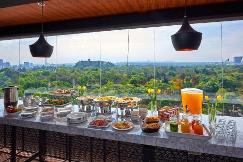 a buffet of food and drinks on a table with a view at Wyndham Garden Mexico City - Polanco in Mexico City