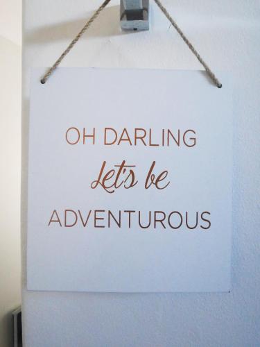 a sign that says on dancing lets be adventurers at DysArt Boutique Hotel - Solar Power in Cape Town