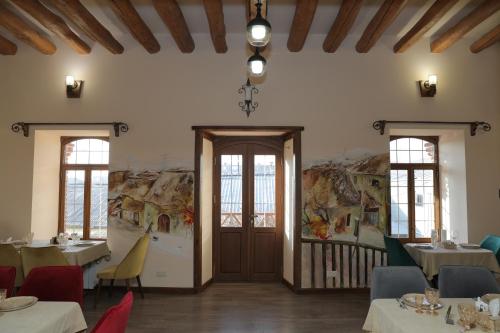 a restaurant with tables and chairs in a room at H Resort Hotel Vagharshapat Armenia in Vagharshapat