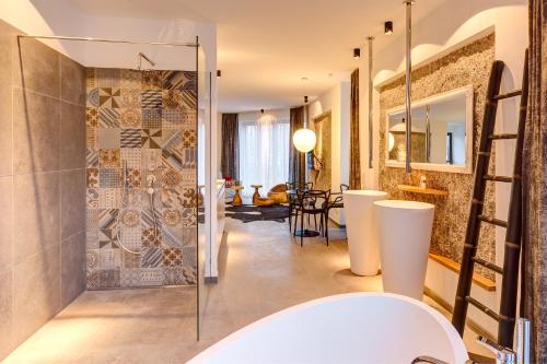 a bathroom with a glass shower and a sink at Hotel im Bunker in Munich