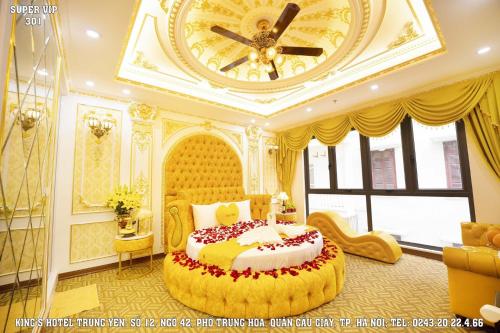 a bedroom with a large bed with a large clock on the ceiling at King’s hotel Trung Yên in Hanoi