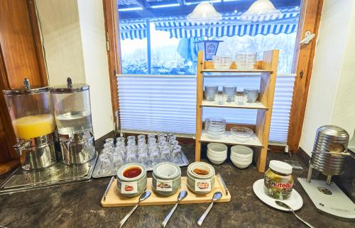 a kitchen with a blender and a shelf of food at Landhotel Krone in Oberreute