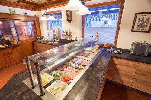 a buffet in a kitchen with many different types of food at Landhotel Krone in Oberreute