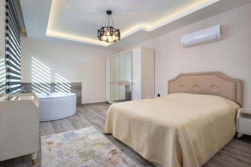 a bedroom with a large bed and a bath tub at Orion Apart Tekirova in Kemer