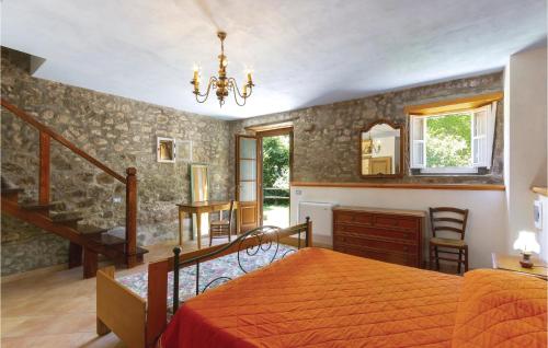 a bedroom with a bed and a staircase at Stunning Home In Casoli Lu With 2 Bedrooms in Cocciglia