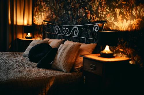 a bedroom with a bed with pillows and two lamps at AVA HOUSE in Kranjska Gora
