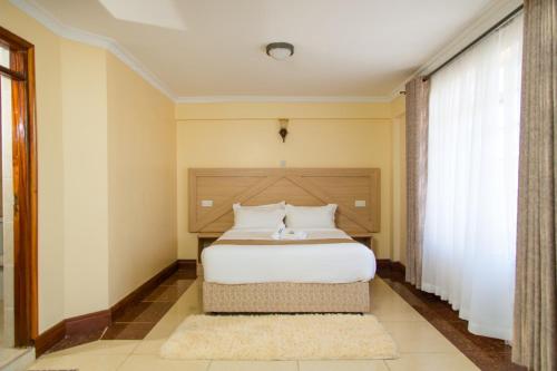 Кровать или кровати в номере Acacia Luxurious Apartment