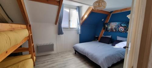 1 Schlafzimmer mit 2 Etagenbetten und einer blauen Wand in der Unterkunft La BREZOUNIÉRE 2 in Risoul