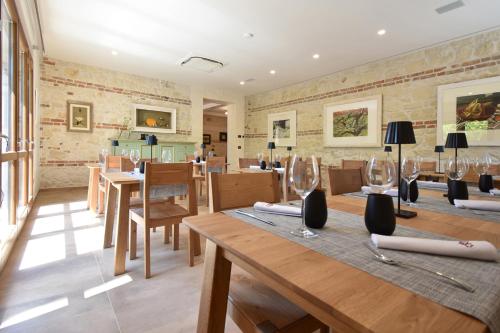 a dining room with wooden tables and chairs at Tenuta Micoli in Frisa